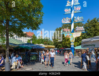 Le bancarelle del mercato nel Viktualienmarkt vicino al Maibaum (Maypole), Monaco di Baviera, Germania Foto Stock