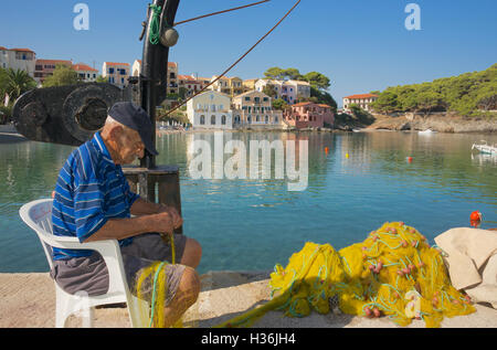 Vecchio Pescatore riassettavano le reti da pesca Assos Cefalonia ISOLE IONIE Grecia Foto Stock