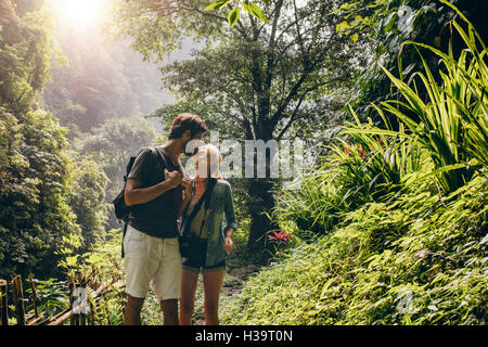 Matura in amore kissing durante le escursioni nella natura. Romantico giovane uomo e donna baciare sulla pista forestale. Foto Stock