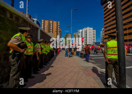 Lungo la linea di poliziotti ecuadoriana manifestanti di supervisione da parte di Unidad Popular marciando nella città capitale Quito contro il governo presidente Rafael Correa Foto Stock