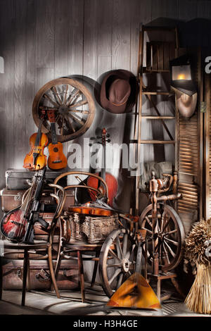 Natura morta con strumenti musicali antichi, sedie e ruota di filatura Foto Stock