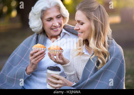 Due affascinanti donne piacevole sedersi per terra Foto Stock