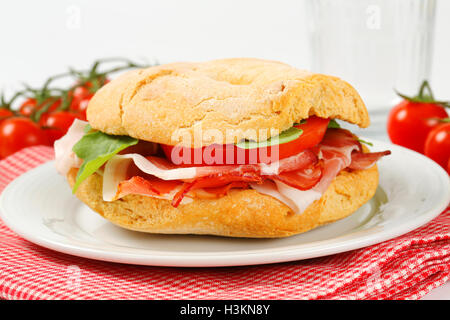 L'anello a forma di rotolo di pane con fette di prosciutto Foto Stock