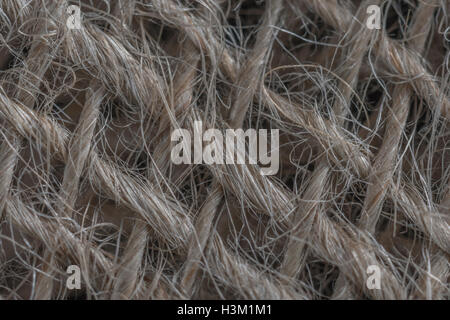Macro-fotografia di fibra naturale, iuta-simili saccheggi materiale che mostra il dettaglio delle filettature fini. Foto Stock