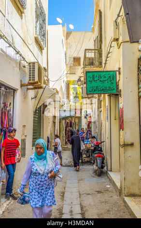La strada stretta di Sfax Medina con molti piccoli negozi e bancarelle a Sfax. Foto Stock