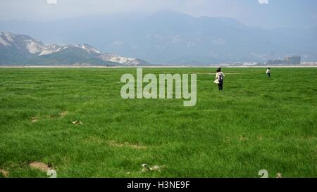 Nanchang, cinese della provincia di Jiangxi. 10 ottobre, 2016. La gente a piedi sul letto esposta del Lago Poyang nella città di Lushan, Cina orientale della provincia di Jiangxi, Ottobre 10, 2016. Cina il più grande lago d'acqua dolce, Lago Poyang, ha visto ridurre drasticamente il livello di acqua negli ultimi giorni. Il lago ha colpito a basso livelli di acqua di circa 54 giorni prima rispetto alla media degli anni precedenti, secondo le statistiche del Jiangxi provinciale ufficio idrografico. © Hu Chenhuan/Xinhua/Alamy Live News Foto Stock