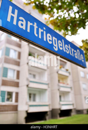 L'edificio residenziale in cui il fuggitivo sospetta terrorista Jaber al-Bakr stato arrestato il 10 ottobre 2016 è visto dietro il cartello stradale a Leipzig, Germania, 11 ottobre 2016. Il 22-anno-vecchio al-Bakr fu preso dal compagno di rifugiati siriani e consegnato alla polizia di lunedì sera. Foto: Jan Woitas/dpa Foto Stock