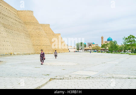 I massicci bastioni della fortezza di arca con il Po-ho Kalyan complesso sullo sfondo a Bukhara. Foto Stock