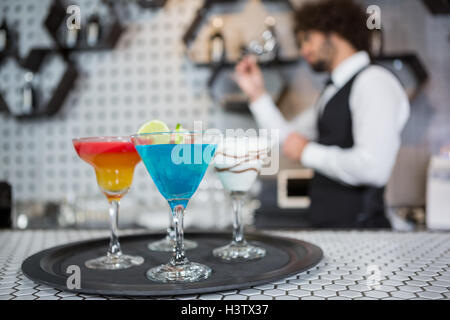 Vari cocktail su un piatto di portata nel bancone bar Foto Stock