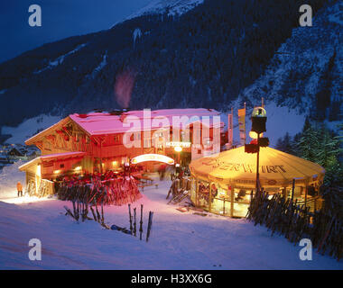 Austria, mountain Arl, San Anton, rifugio sciistico, proteggibili, crepuscolo, inverno Europa, sport invernali luogo turistico, bar, ristorante, Mooserwirt, Apres Ski, ospiti, sciatori, celebrare, divertimento, svago, Heierkeit, gastronomia, Winteruralub, vacanza sciistica, turismo Foto Stock