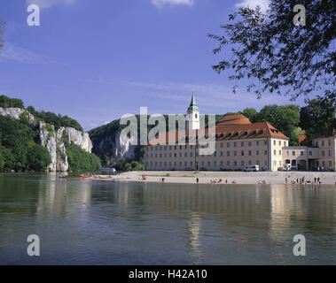 Germania, Bassa Baviera, chiostro del castello del mondo, il fiume Danubio, Germania meridionale, bavaresi, chiostro benedettino, il chiostro e chiesa abbaziale, architettura, luogo di interesse, destinazione, il turismo, la fede, la religione, il cristianesimo, chiesa, Steeple, abbazia, rock, shore, spiaggia, turistico, balneazione, persone Foto Stock