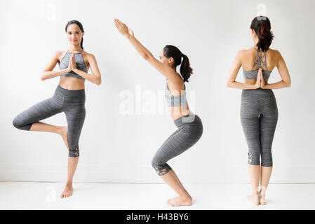 Serie di razza mista donna fare yoga pone Foto Stock