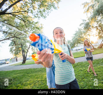 Ragazze caucasica giocando con squirt pistole Foto Stock