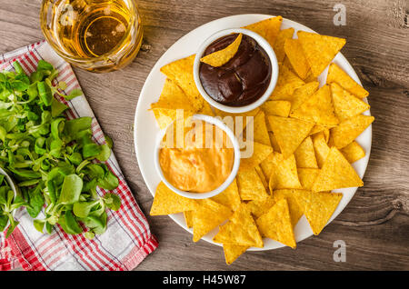 Tortilla chips con formaggio dip e barbecue, birra ceca Foto Stock