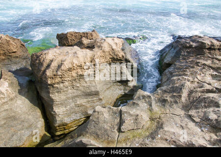 Vista aerea del le acque dell'Oceano Indiano rushing calcare formazioni rocciose a spiaggia remota sulla Penguin Island in Australia Occidentale. Foto Stock