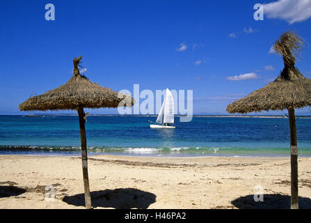 In Spagna, le isole Baleari, isola di Maiorca, Colonia de Sant Jordi, spiaggia, mare, schermi, ombrelloni, catamarano, barca, nessuno, spiaggia sabbiosa, catamarano a vela, il Mar Mediterraneo, vacanza, il sole, riposo, Foto Stock