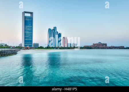 Tramonto sull'Abu Dhabi Corniche con edifici moderni che domina lo skyline Foto Stock