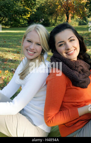 Le donne, due, sorridente, seduti, in vista laterale Foto Stock