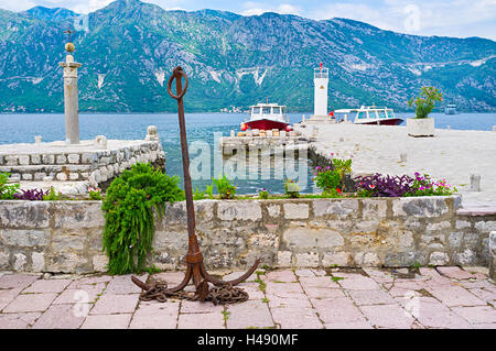 Il Rusty ancora impostato come decorazione sulla Nostra Signora delle rocce isoletta accanto al porticciolo per le imbarcazioni turistiche, Perast Foto Stock