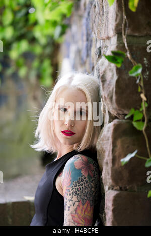 Giovane donna bionda, tatuato Foto Stock