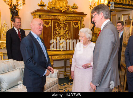 Queen Elizabeth II incontra la Croce Rossa Direttore Esecutivo di fundraising Marco Astarita (sinistra) e la Croce Rossa Chief Executive Michael Adamson (a destra), all'inaugurazione di un ritratto della sua dall artista britannico Henry Ward, segnando sei decenni di patrocinio alla Croce Rossa Britannica, che è stato presentato al Castello di Windsor in Berkshire. Foto Stock