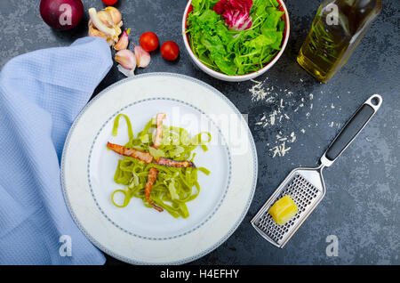 Italian pasta agli spinaci con organici aglio e pancetta e formaggio parmigiano Foto Stock