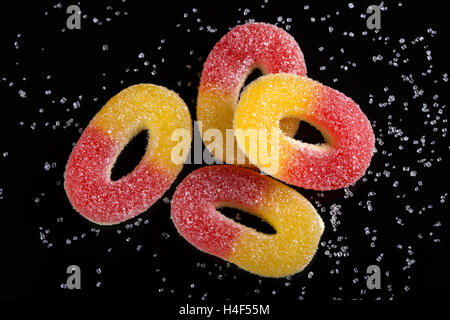 Jelly caramelle con zucchero bianco su sfondo nero Foto Stock