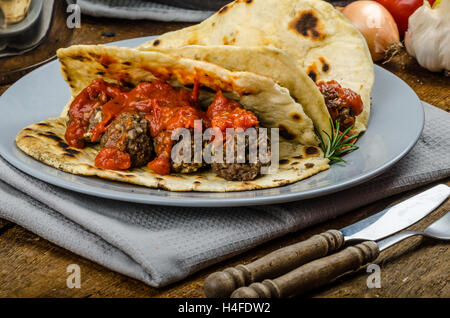 Naan indiano con polpette di carne e salsa di pomodoro con salsa piccante e esotici da pane naan indiano Foto Stock