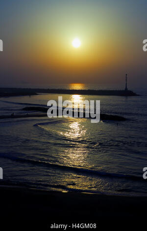 Il faro sul molo al tramonto nel Mare Mediterraneo Foto Stock