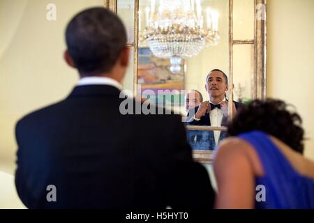 Stati Uniti Presidente Barak Obama regola la cravatta prima dello stato la cena in onore del Presidente messicano Felipe Calderon nella Casa Bianca giallo sala ovale 19 Maggio 2010 a Washington, DC. Foto Stock