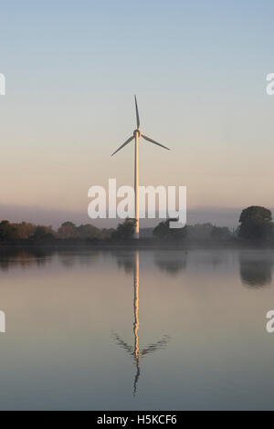 Turbina eolica e riflessione a sunrise. Serbatoio Boddington, Northamptonshire, Regno Unito Foto Stock