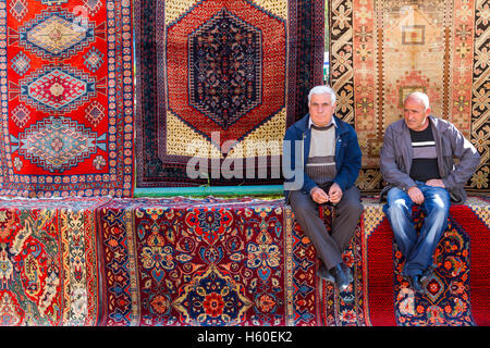 Due uomini armeni seduti sui tappeti del mercato Vernissage a Yerevan, Armenia. Foto Stock