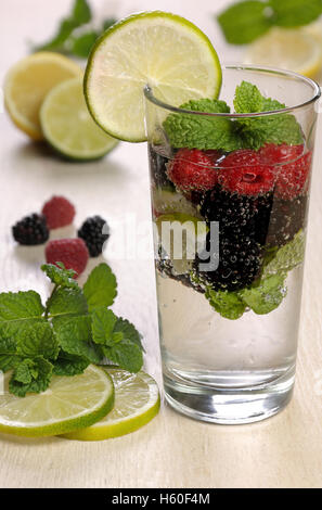 Un bicchiere di limonata dalle bacche di blackberry e lampone con lime e menta Foto Stock