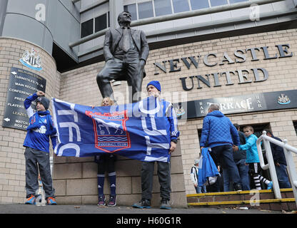 I fan di Ipswich posano per le foto con il sir Bobby Robson statua durante il cielo di scommessa match del campionato a St James Park, Newcastle. Foto Stock