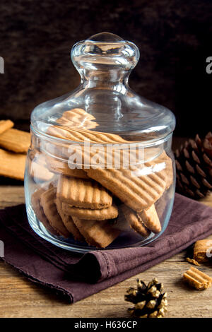 In casa piccante biscotti allo zenzero in un barattolo di vetro su tavola in legno rustico, inverno gustosa pasticceria allo zenzero Foto Stock