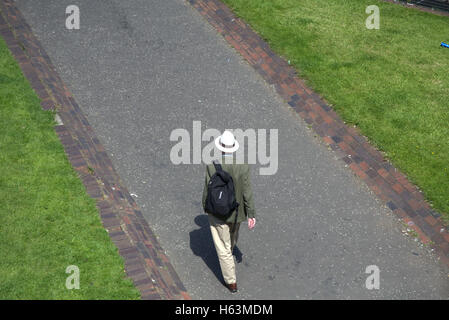 Ben vestito gentleman inglese in un cappello di Panama in stile di cricket camminando per strada Foto Stock