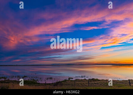 I colori del tramonto su lago Deadhorse nel sud Alberta, in data 8 luglio 2016. La luna crescente splende in mezzo il clou colorati Foto Stock