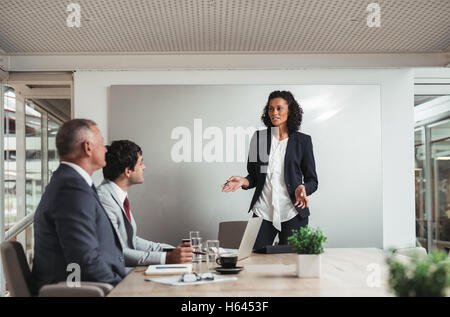 Discutere la strategia con la squadra nella sala riunioni Foto Stock