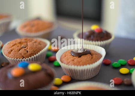 Fatti in casa muffin al cioccolato con glassa Foto Stock