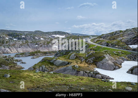 Scenic paesaggio norvegese con rocce, il lago e la curva della strada di montagna. Foto Stock