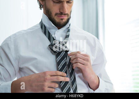 Uomo di vestirsi in camera da letto Foto Stock