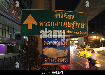 Un cartello per la direzione del convento del Santo Bambino Gesù Scuola nel centro cittadino di Bangkok, Tailandia. Foto Stock