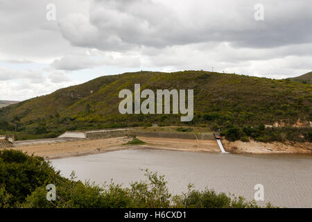 Basso livello dell'acqua presso la diga Loerie in un giorno nuvoloso. Foto Stock