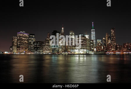 Un tempo di notte vista di Manhattan inferiore attraverso l'East River da Brooklyn, NY, Stati Uniti. Foto Stock