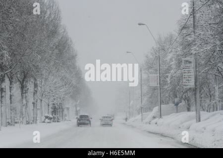 Bucarest, Romania, 17 Gennaio 2016: automobili sono visibili su una strada, durante una nevicata a Bucarest. Foto Stock