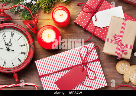 Regalo di natale scatole, sveglia e abete su un tavolo di legno. Vista superiore Foto Stock