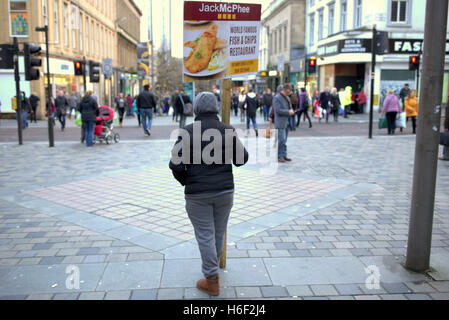 Panino tipo board street pubblicità pesce e patatine studente targhetta salario minimo lavoratore straniero Sauchiehall St marciapiede Foto Stock