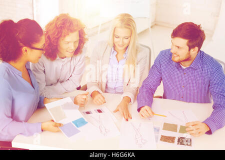 smiling creative team looking at sketch Foto Stock