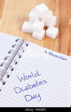 Iscrizione La giornata mondiale del diabete per i notebook e i cubetti di zucchero, simbolo di diabetici e per la lotta contro il diabete Foto Stock