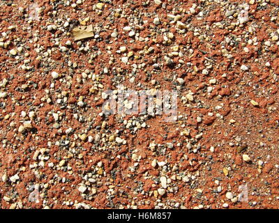 Sabbia rossa con pietre Foto Stock